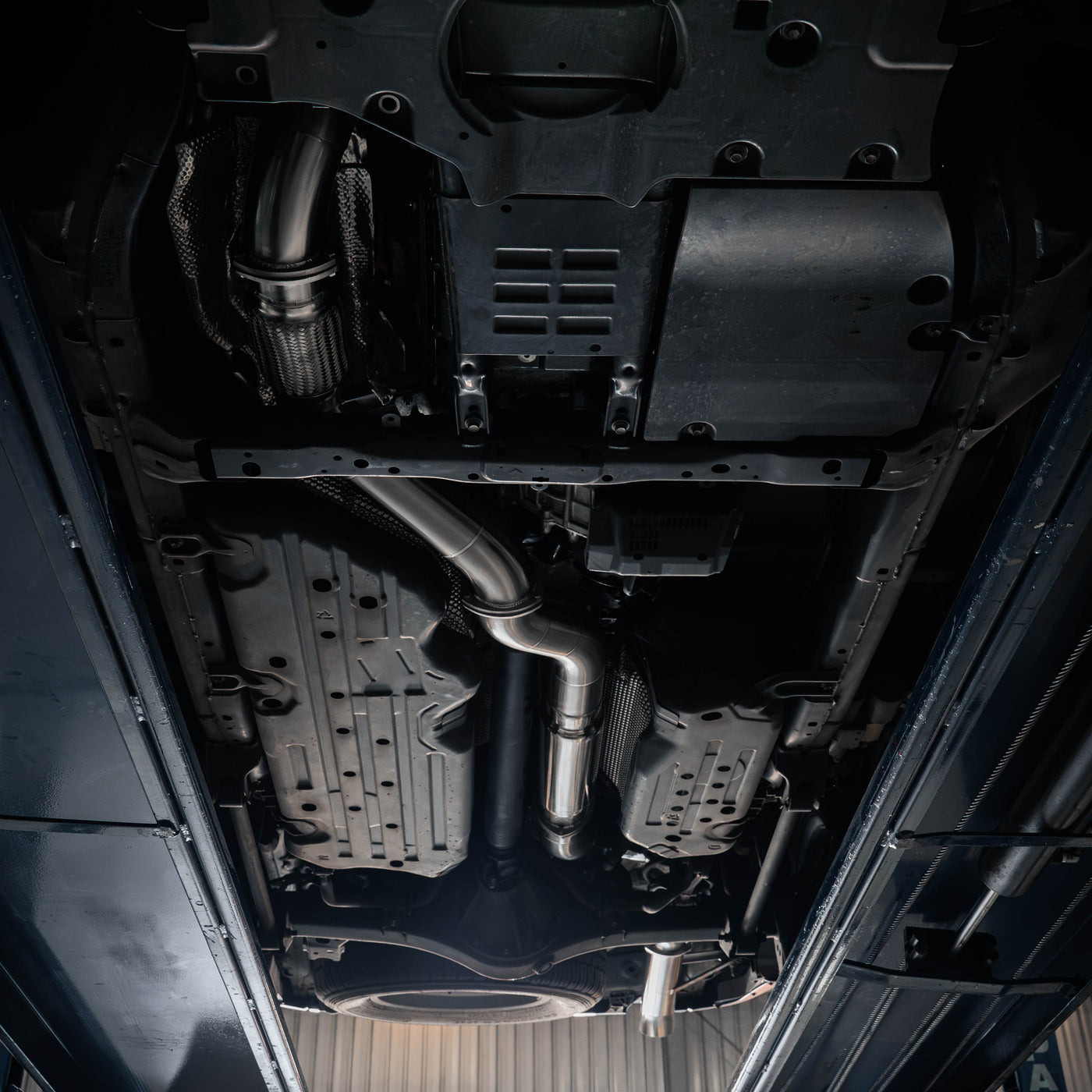 Close-up view of a car's undercarriage with various mechanical components.