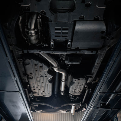 Close-up view of a car's undercarriage with various mechanical components.