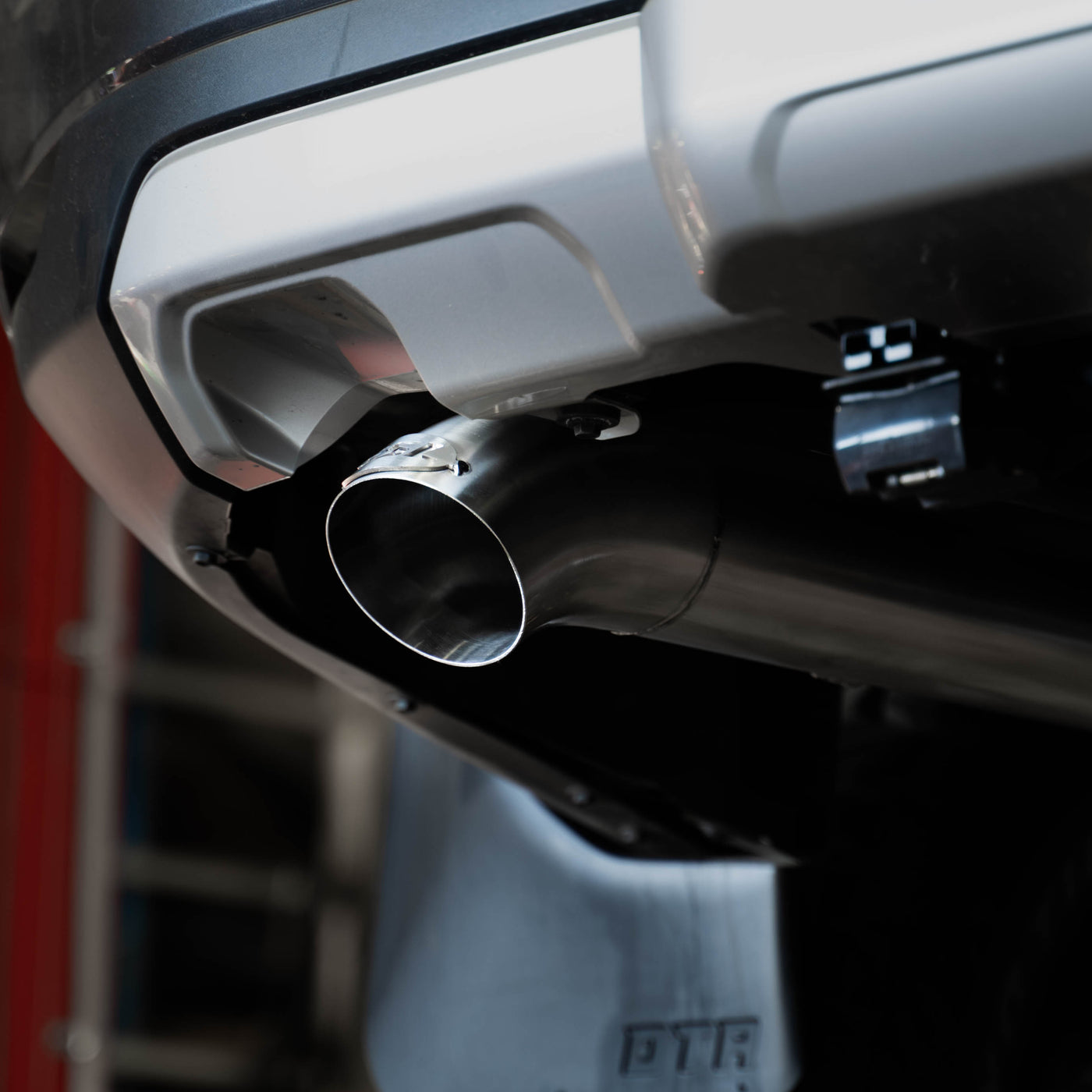 Close-up of a car exhaust system with a blurred background